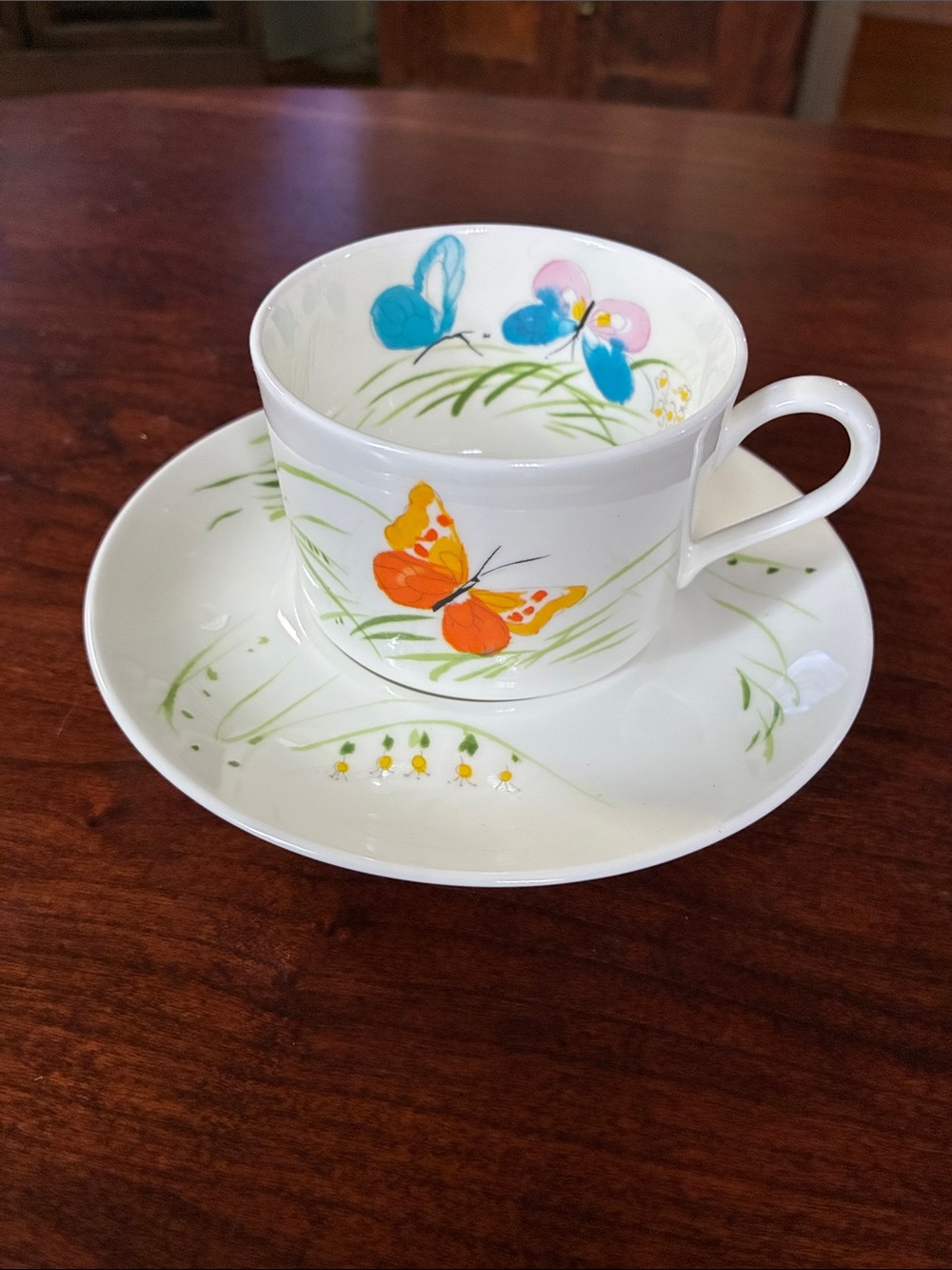 Mikasa White Cup and Saucer with Orange Butterfly and Blue Floral Accents